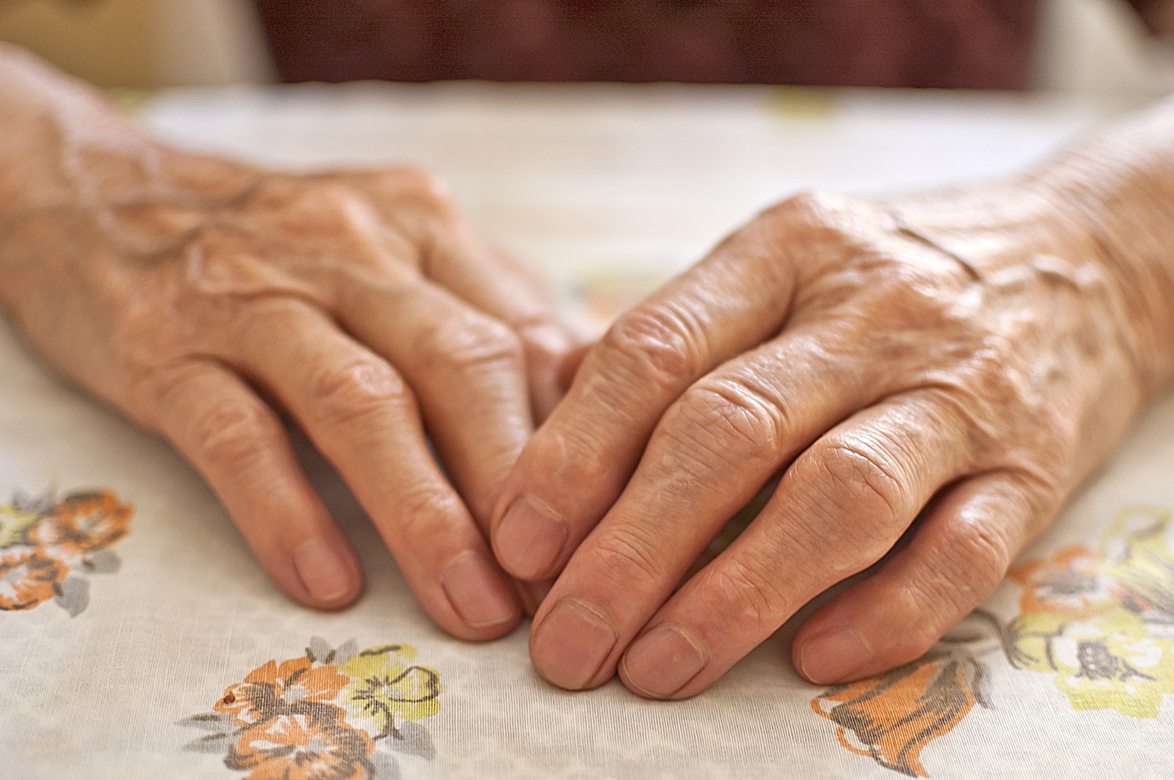 An elderly person's hands.