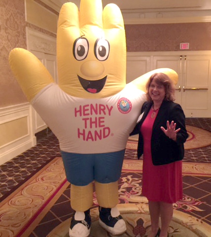 Sue Peschin with Henry the Hand mascot.