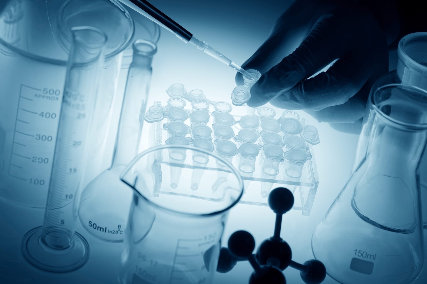 Scientist putting liquid in test tubes.