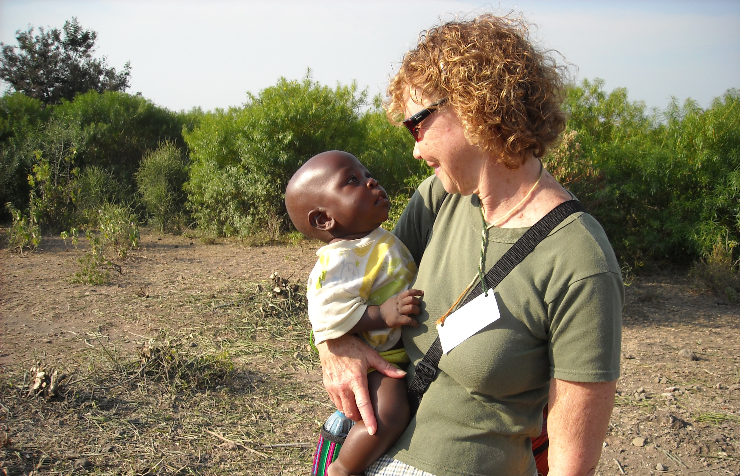 Sandy holding a baby on a mission trip in Kenya.