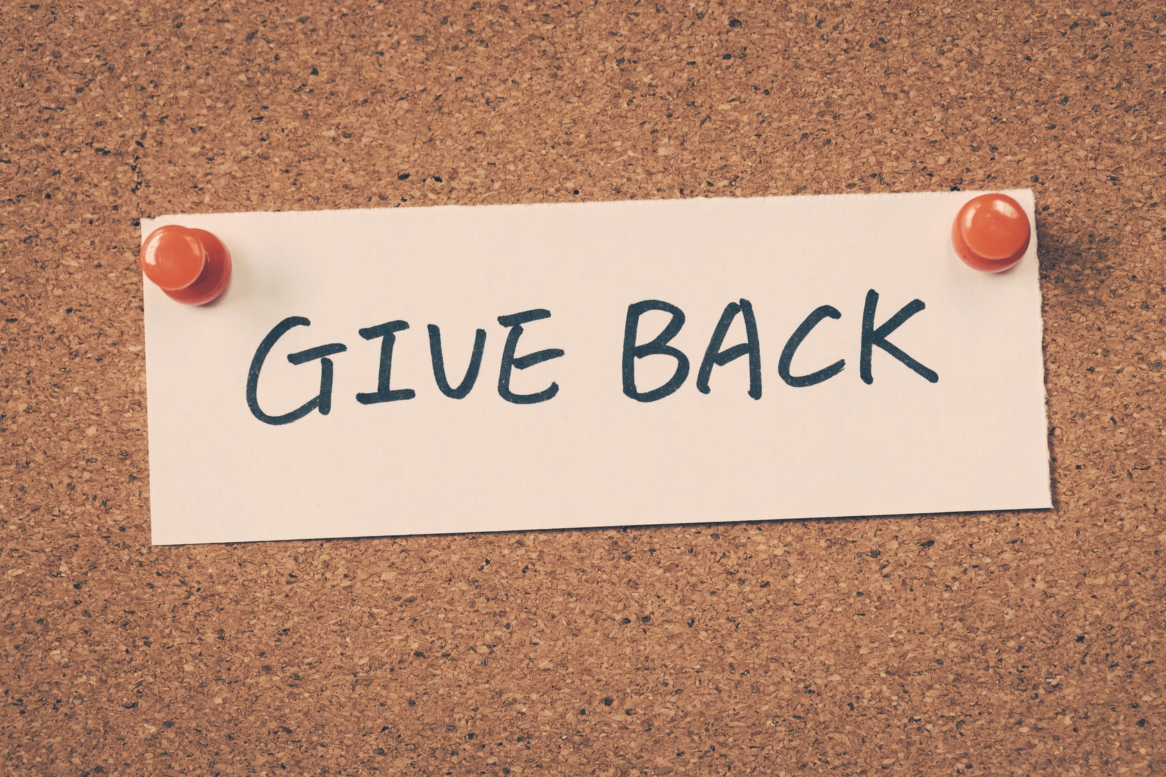 Bulletin board with text "give back."