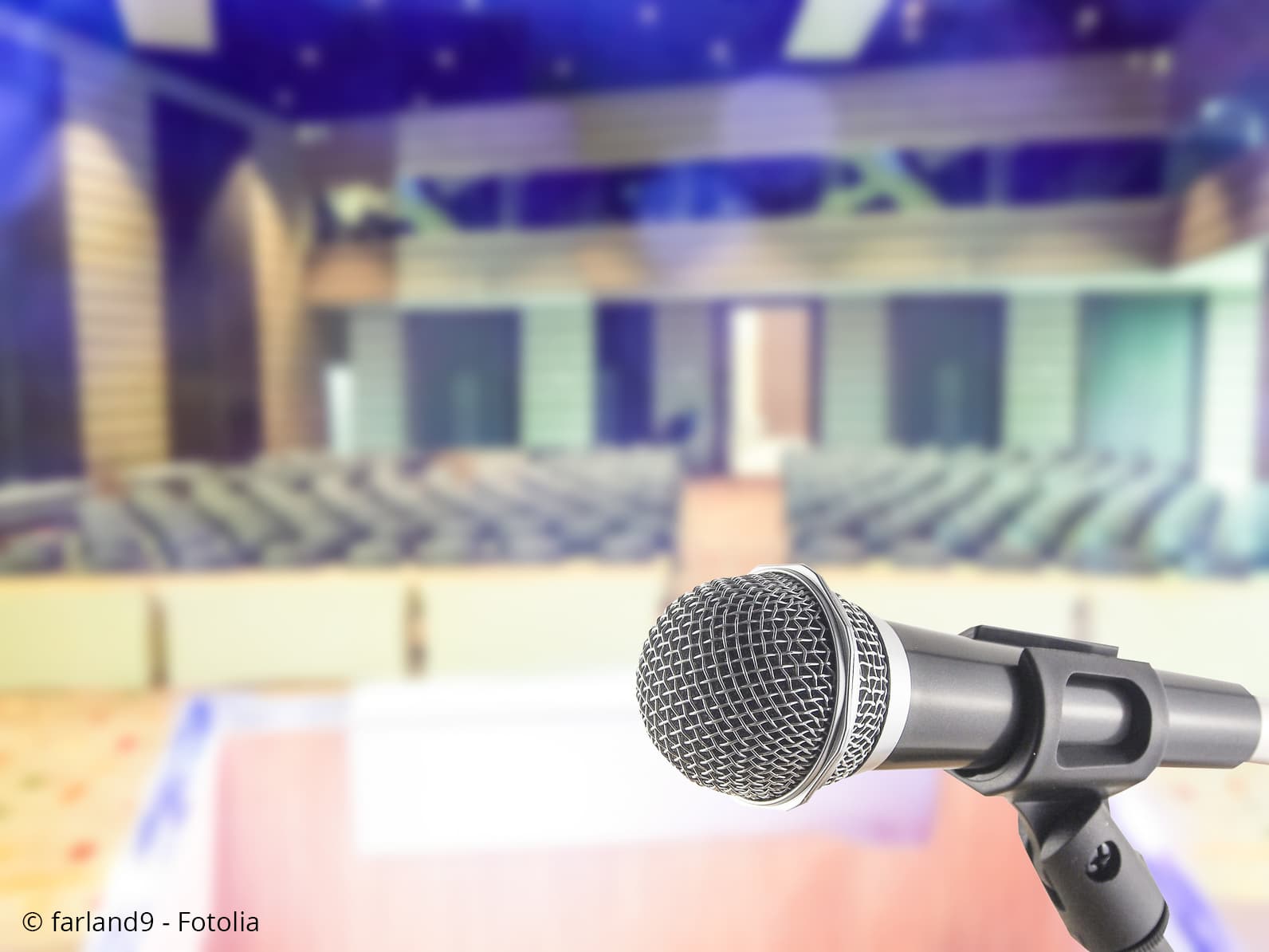 Microphone in front of empty seats.