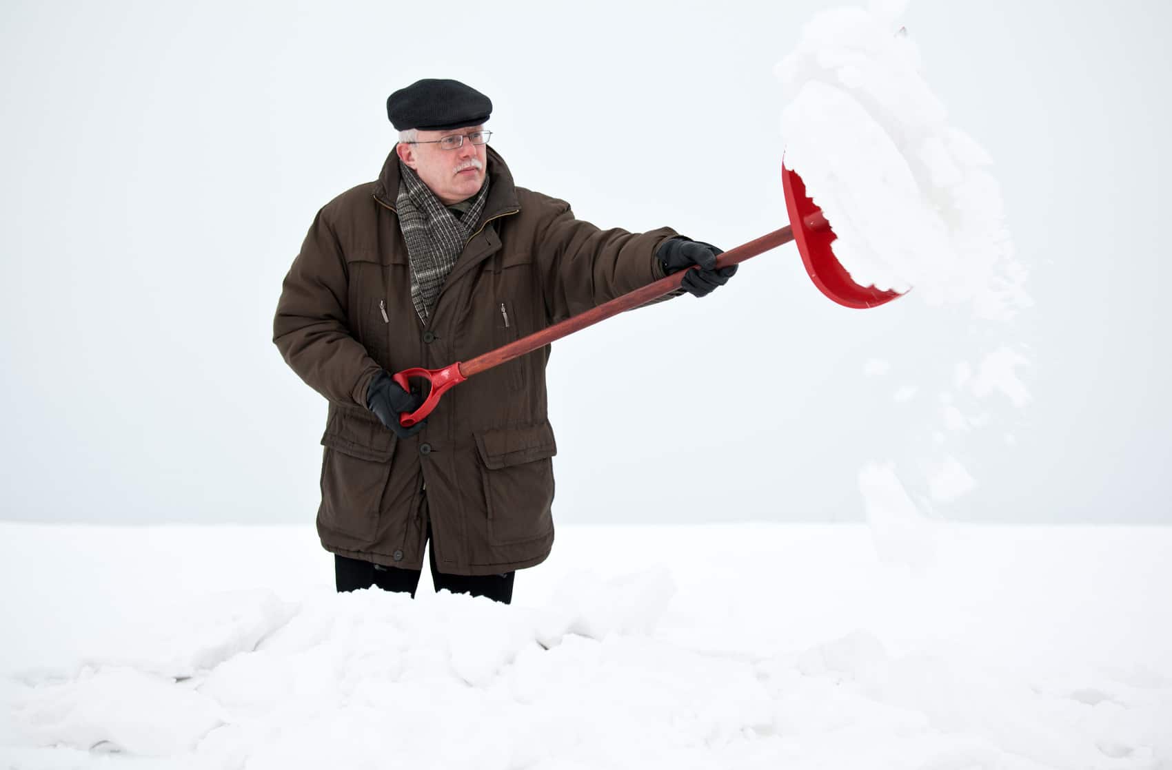 Elderly man shoveling snow.