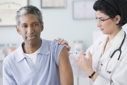 Older man receiving a vaccine.