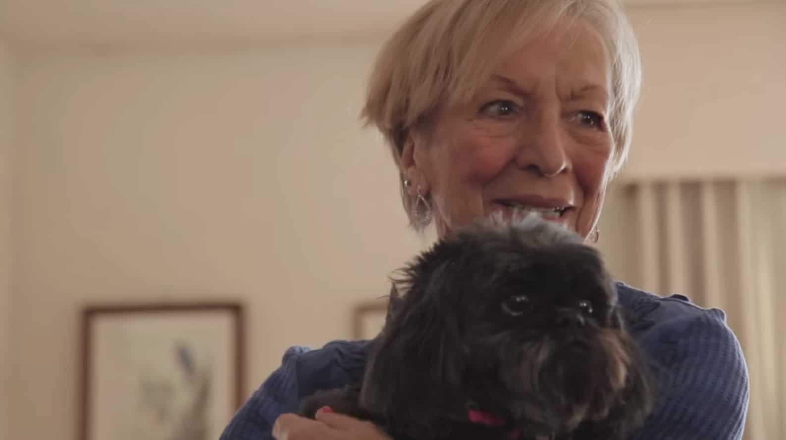 Screengrab of Nina Bamford with her dog from "Living with Valve Disease" video.