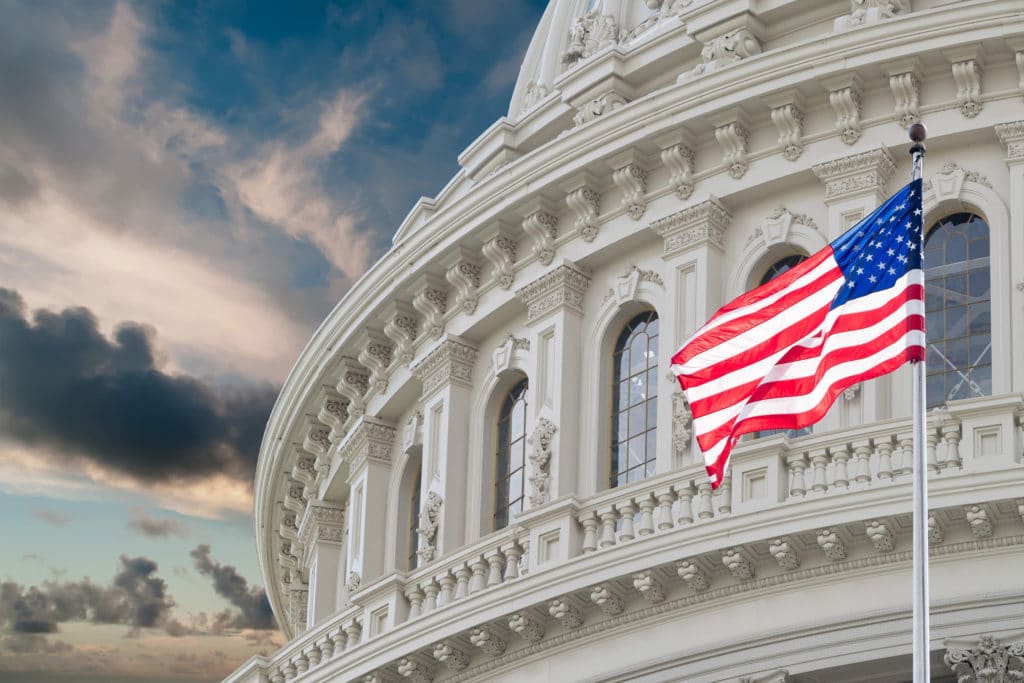 United States Capitol building with American flag waving.