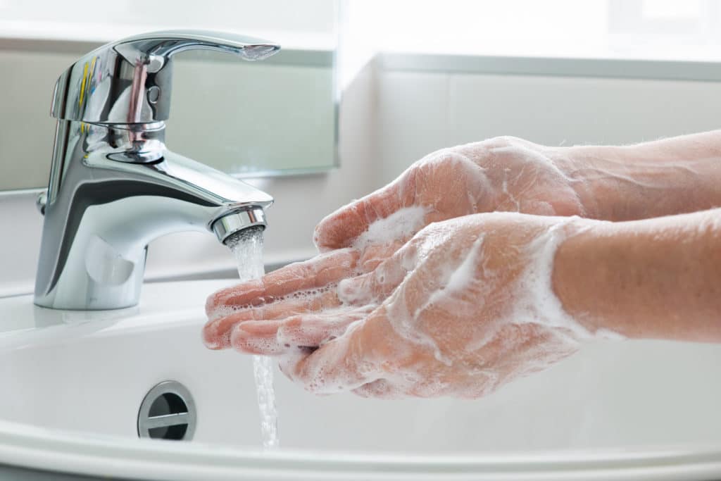 Person washing their hands with soap.