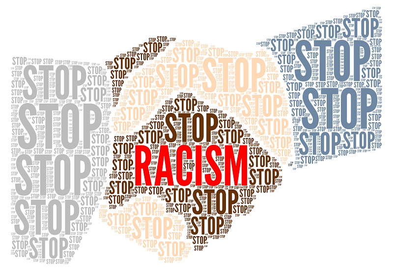 Handshake between black and white persons with the phrase "stop racism."