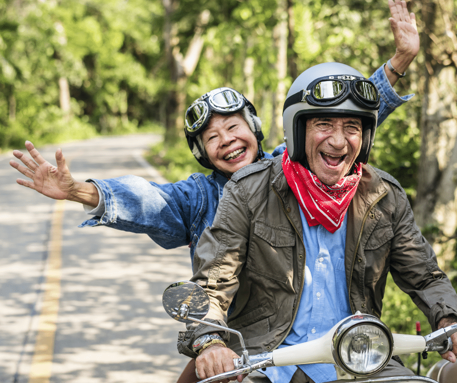 Senior couple riding motorbike.