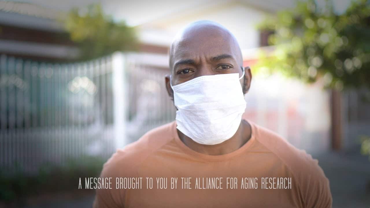 Man wearing face mask overlaid with text "a message brought to you by the alliance for aging research."