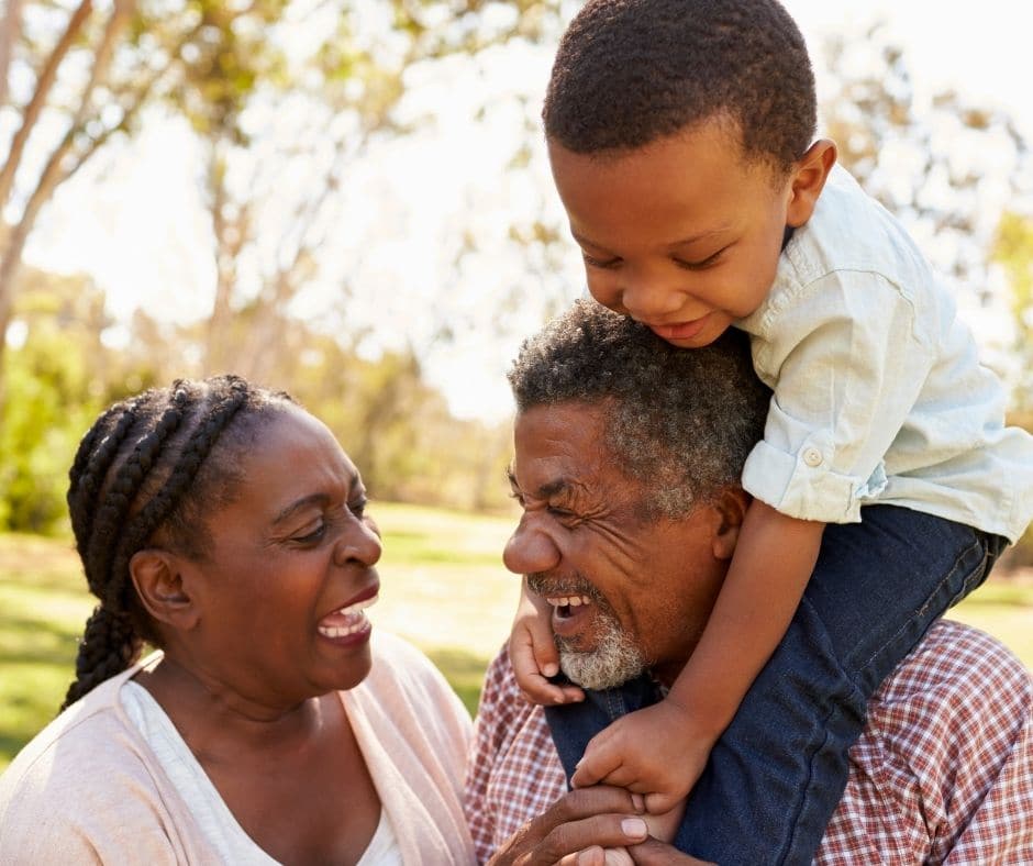 Three generations of family laughing together.