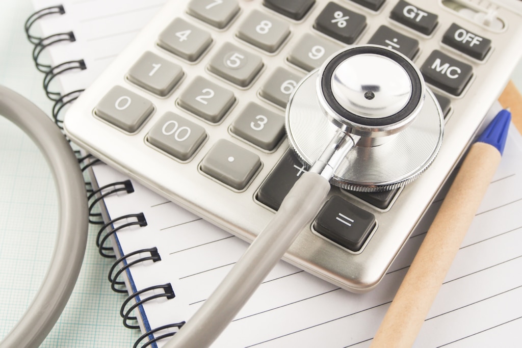 Stethoscope resting on a calculator