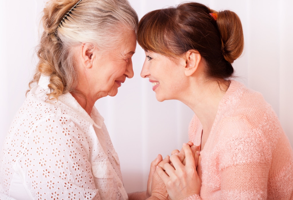 Senior woman head to head with her daughter/caregiver