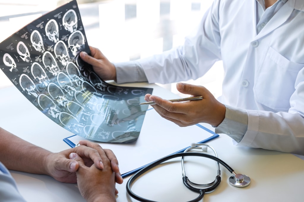 A physician explaining a brain scan to a patient.