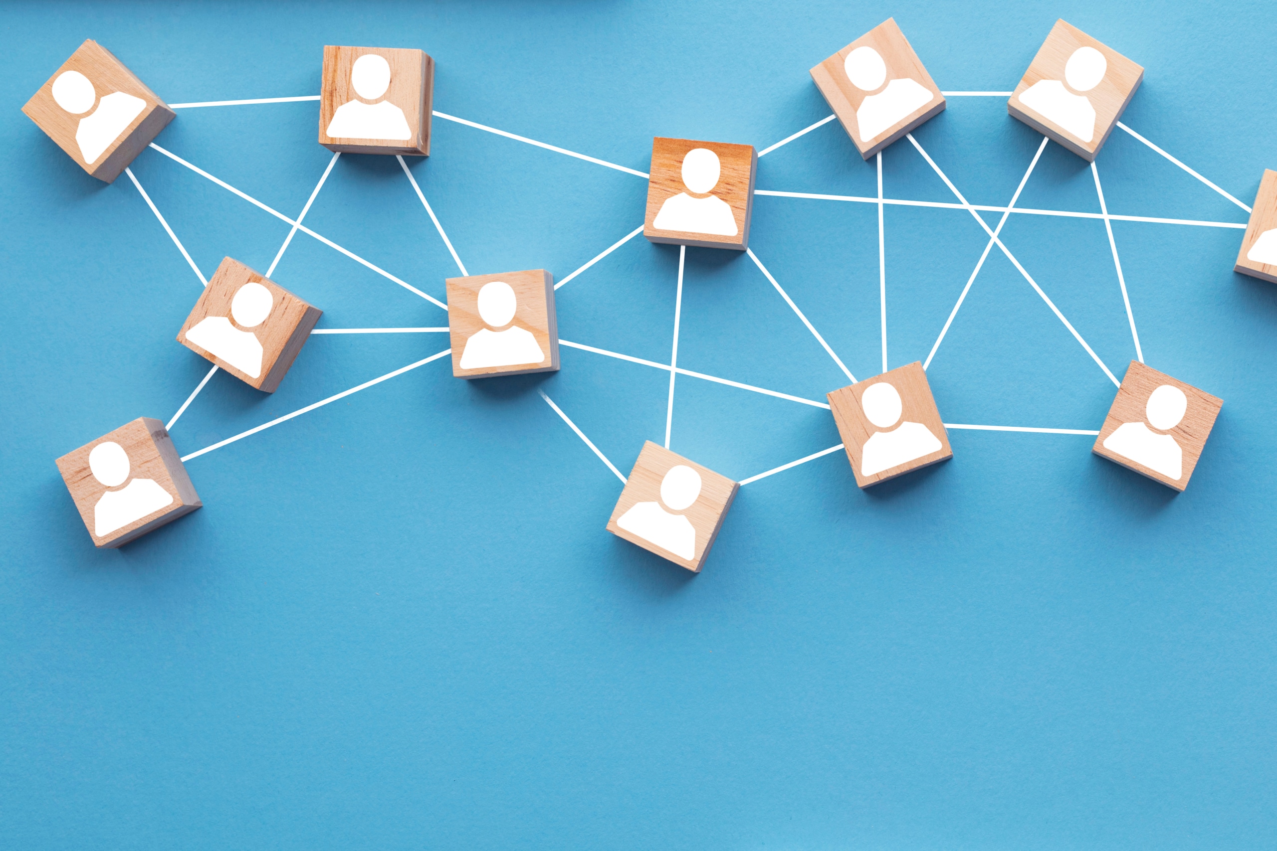 Wooden blocks connected together on a blue background. Teamwork concept