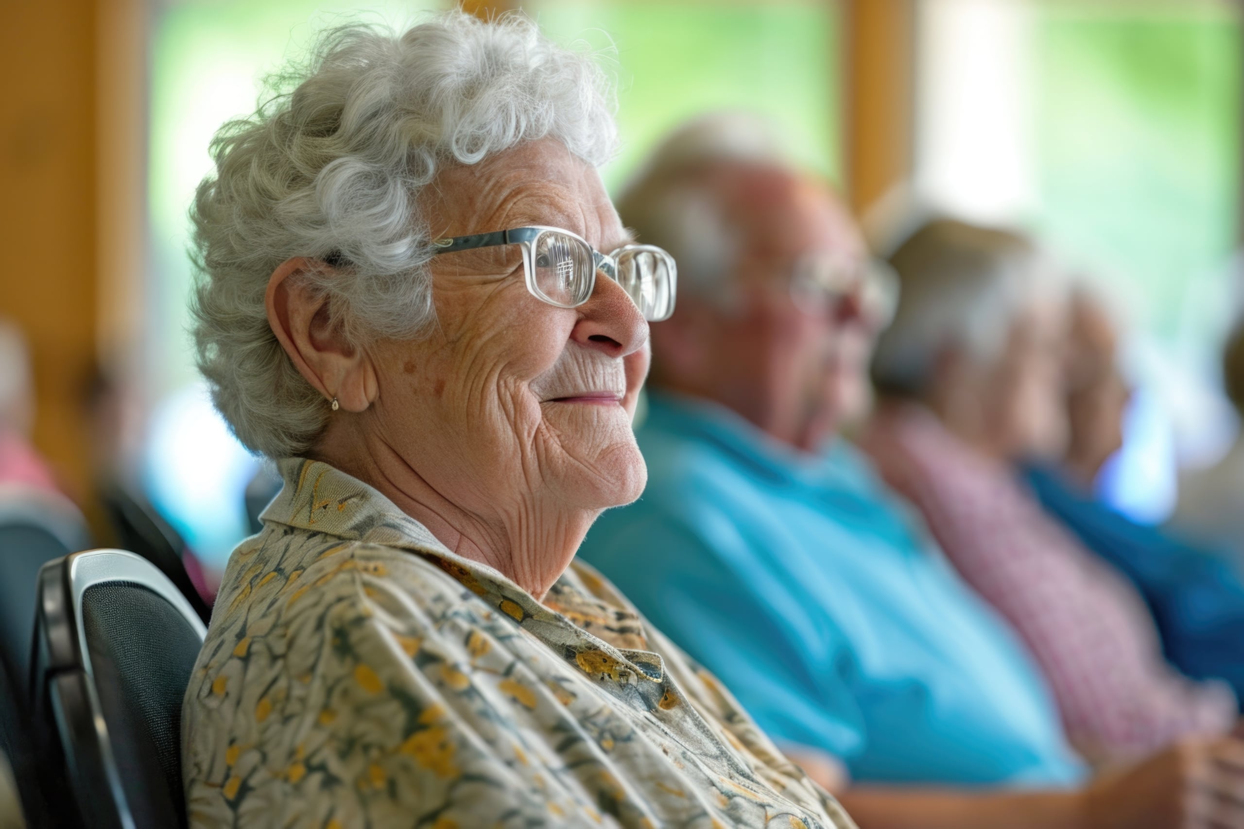 Older woman smiling in foreground with other older adults in background.