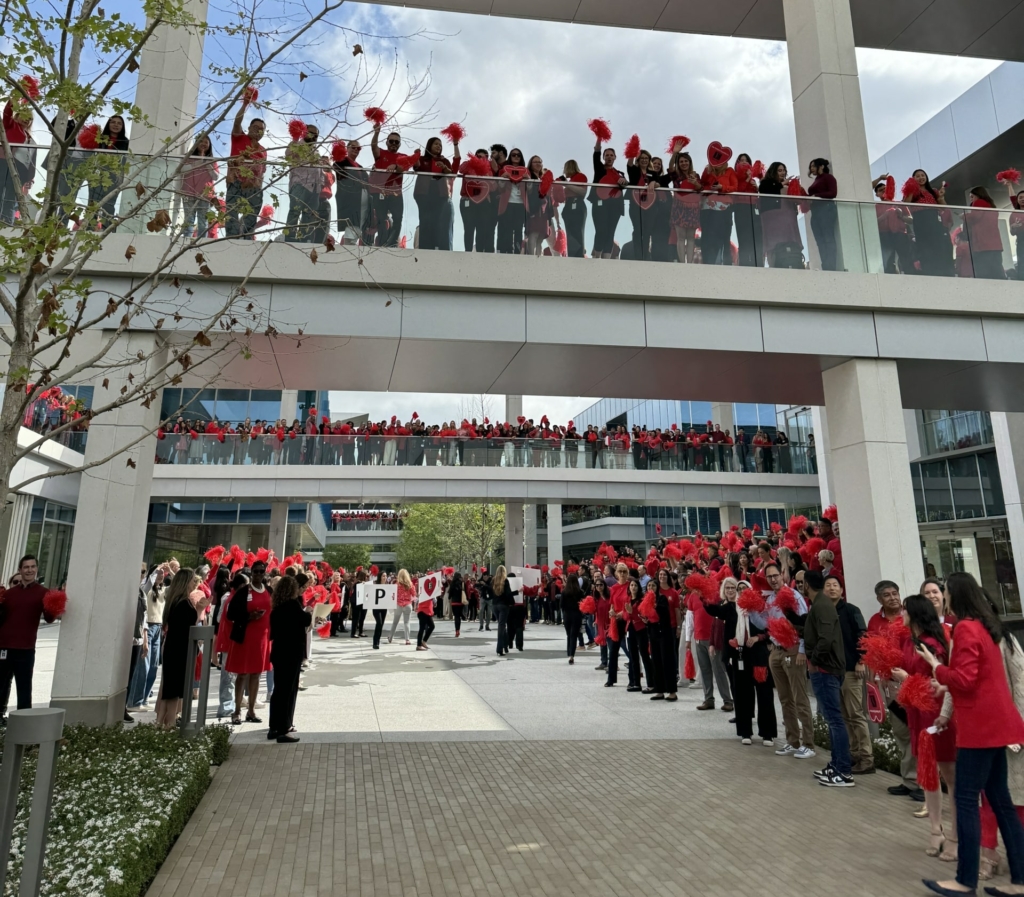 Dressed in red and lining walkways and pedestrian bridges, most of the 5,000 Edwards Lifesciences employees welcome patients the the Patient Experience on May 9 its global headquarters in Irvine, Calif.