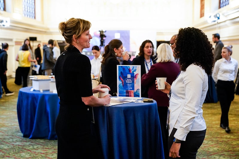 People mingling while sipping coffee before the event began