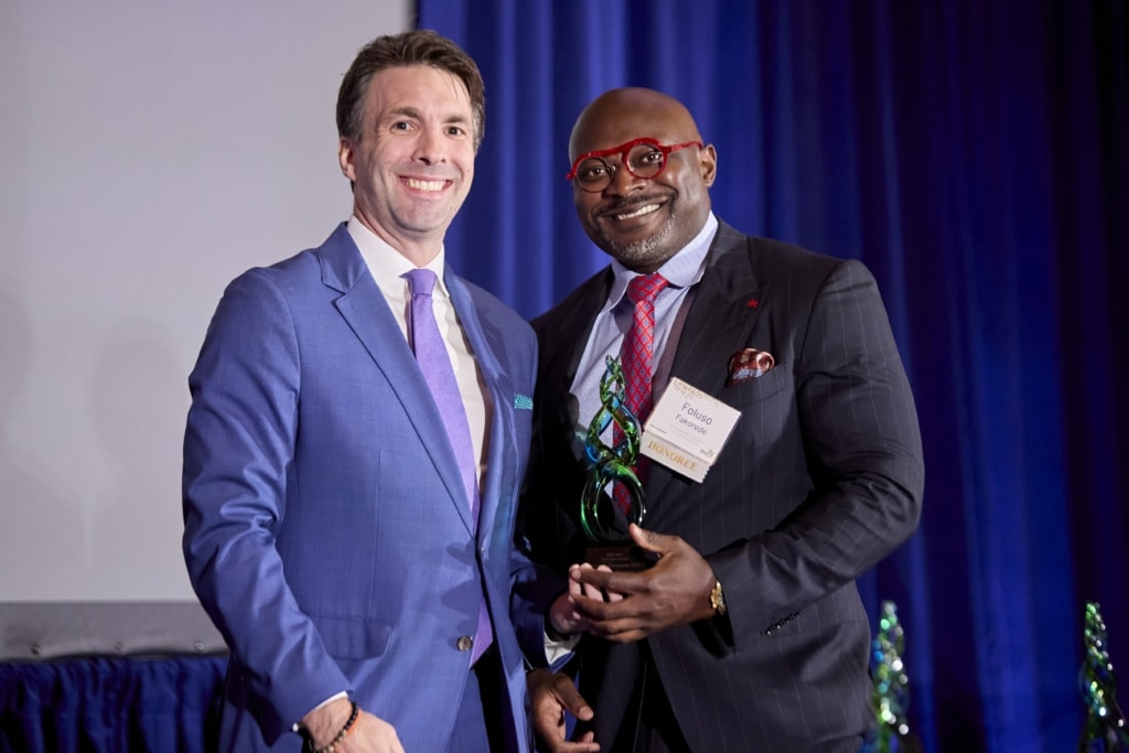 Dr. Fakorede (right) accepts his award from Bobby Patrick VI.